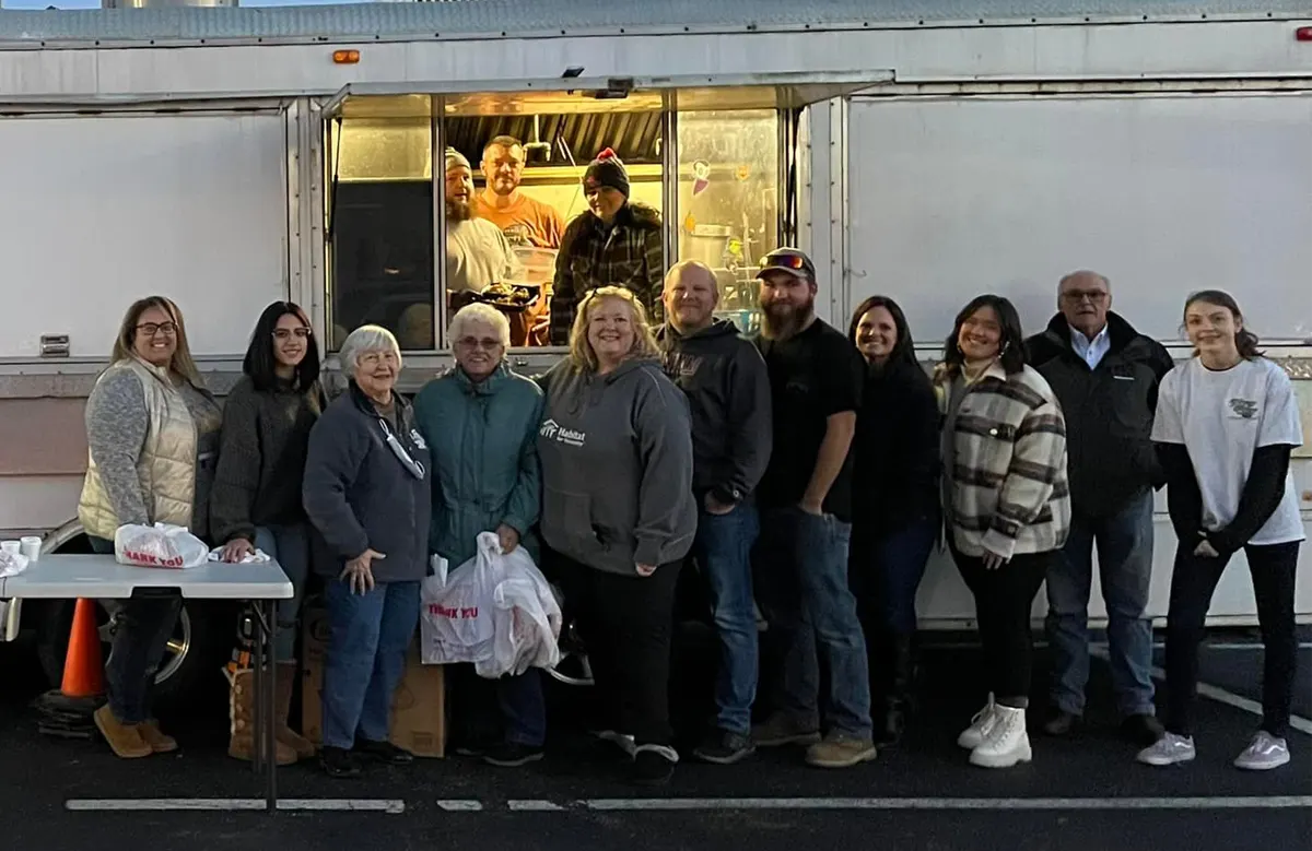 Volunteers who helped standing in front of food truck